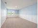 Bedroom with light blue walls and window at 16632 Goose Ribbon Pl, Wimauma, FL 33598