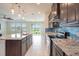 Kitchen with granite countertops, stainless steel appliances, and backyard view at 16632 Goose Ribbon Pl, Wimauma, FL 33598