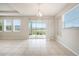 Dining area with sliding glass doors and view of lake at 16632 Goose Ribbon Pl, Wimauma, FL 33598