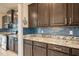 Well-equipped kitchen with ample counter space and dark wood cabinets at 16632 Goose Ribbon Pl, Wimauma, FL 33598