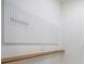 White pegboard wall with wooden shelf and hooks at 16632 Goose Ribbon Pl, Wimauma, FL 33598