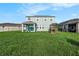 Large backyard with green grass and two story house at 16632 Goose Ribbon Pl, Wimauma, FL 33598