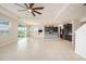 Open concept living room and kitchen with tile floors at 16632 Goose Ribbon Pl, Wimauma, FL 33598
