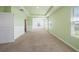 Large bedroom with light green walls and carpet at 16632 Goose Ribbon Pl, Wimauma, FL 33598