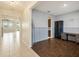 Home office with wood-look tile floors and built-in shelving at 16632 Goose Ribbon Pl, Wimauma, FL 33598