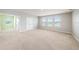 Spacious bedroom with large windows and neutral carpeting at 16632 Goose Ribbon Pl, Wimauma, FL 33598