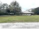 Single story home with carport and expansive lawn at 30737 Elam Rd, Wesley Chapel, FL 33545