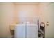 Laundry room with washer, dryer, and shelving at 630 Tremont Greens Ln # 95, Sun City Center, FL 33573