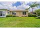 Backyard with grassy area and access to home at 630 Tremont Greens Ln # 95, Sun City Center, FL 33573