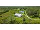 Aerial view of home on a spacious lot with lush vegetation at 6701 Verna Bethany Rd, Myakka City, FL 34251