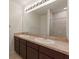 Double vanity bathroom with dark brown cabinets and granite countertop at 10920 Carlton Fields Dr, Riverview, FL 33579