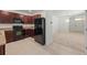 Kitchen with dark brown cabinets and black appliances at 10920 Carlton Fields Dr, Riverview, FL 33579