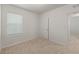 Bright bedroom with window, blinds, and door at 10920 Carlton Fields Dr, Riverview, FL 33579