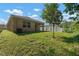 Landscaped backyard with a spacious grassy area at 10920 Carlton Fields Dr, Riverview, FL 33579