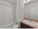 Clean bathroom with a shower/tub combo and dark vanity at 10920 Carlton Fields Dr, Riverview, FL 33579