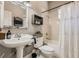 Quaint bathroom with pedestal sink and shower/tub combo at 5602 N Ola Ave, Tampa, FL 33604