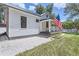 Charming white cottage with a metal roof and porch at 5602 N Ola Ave, Tampa, FL 33604