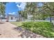 Charming white cottage with a metal roof and porch at 5602 N Ola Ave, Tampa, FL 33604