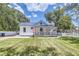 Charming white cottage with a metal roof and porch at 5602 N Ola Ave, Tampa, FL 33604