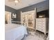 Main bedroom with French doors and built in dresser at 5602 N Ola Ave, Tampa, FL 33604