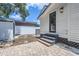 Small backyard with patio, shed, and exterior access to home at 5602 N Ola Ave, Tampa, FL 33604