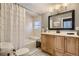 Clean bathroom with a tub shower and wood vanity at 5602 N Ola Ave, Tampa, FL 33604