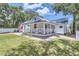 Charming white cottage with a metal roof and porch at 5602 N Ola Ave, Tampa, FL 33604