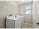 Laundry room with washer, dryer, and shelving at 1653 Ludington Ave, Wesley Chapel, FL 33543