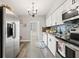 Modern kitchen with white cabinets, wood countertops, and stainless steel appliances at 5728 14Th N Ave # 104B, St Petersburg, FL 33710