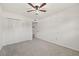 Bright bedroom featuring ceiling fan, carpet, and spacious closet at 5728 14Th N Ave # 104B, St Petersburg, FL 33710