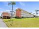 Front view of condo building with parking and landscaping at 5728 14Th N Ave # 104B, St Petersburg, FL 33710