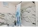 Updated bathroom with marble-tiled walls and a shower/tub combo at 5728 14Th N Ave # 104B, St Petersburg, FL 33710
