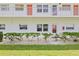Condo building exterior with landscaping and walkway at 5728 14Th N Ave # 104B, St Petersburg, FL 33710