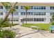 Exterior view of a condo building with palm trees and well-maintained landscaping at 5728 14Th N Ave # 104B, St Petersburg, FL 33710