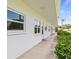 View of condo building hallway with lush green shrubbery at 5728 14Th N Ave # 104B, St Petersburg, FL 33710