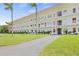 Two-story building with balconies and a well-maintained lawn at 5728 14Th N Ave # 104B, St Petersburg, FL 33710