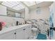Updated bathroom with white vanity, marble tile, and a teal rug at 5728 14Th N Ave # 104B, St Petersburg, FL 33710