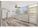 Florida room with large windows, vinyl flooring, and exterior access at 5728 14Th N Ave # 104B, St Petersburg, FL 33710
