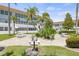 Community courtyard with grills, tables, and lush tropical landscaping at 5728 14Th N Ave # 104B, St Petersburg, FL 33710