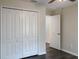 Bedroom with double door closet and wood floors at 16707 Magnolia Reserve Pl, Wimauma, FL 33598
