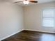 Bedroom with wood floors, window with blinds, and ceiling fan at 16707 Magnolia Reserve Pl, Wimauma, FL 33598