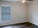 Bright bedroom with wood floors and window with blinds at 16707 Magnolia Reserve Pl, Wimauma, FL 33598