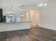 Dining area with hardwood floors and view into the kitchen at 16707 Magnolia Reserve Pl, Wimauma, FL 33598
