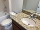 Updated bathroom with granite countertop, single sink vanity, and bathtub at 16707 Magnolia Reserve Pl, Wimauma, FL 33598