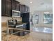 Kitchen with stainless steel appliances and granite countertops at 16707 Magnolia Reserve Pl, Wimauma, FL 33598