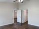 Large bedroom with wood floors and access to closets at 16707 Magnolia Reserve Pl, Wimauma, FL 33598