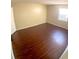Spacious bedroom with dark laminate flooring and a window with blinds at 4335 Aegean Dr # 106A, Tampa, FL 33611