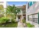 Two-story building with a walkway leading to the unit's entrance at 4335 Aegean Dr # 106A, Tampa, FL 33611