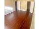 Large bedroom with dark laminate floors and multiple doors at 4335 Aegean Dr # 106A, Tampa, FL 33611
