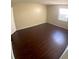Spacious bedroom with dark laminate flooring and a window with blinds at 4335 Aegean Dr # 106A, Tampa, FL 33611